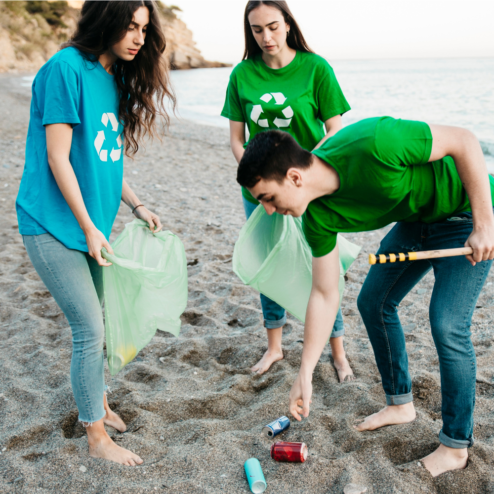 Group of volunteers collecting trash at the beach